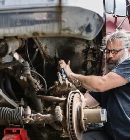 Mature man repairing car